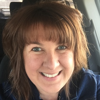 Photo of Mari Schupp, mid-length brown hair, and smiling