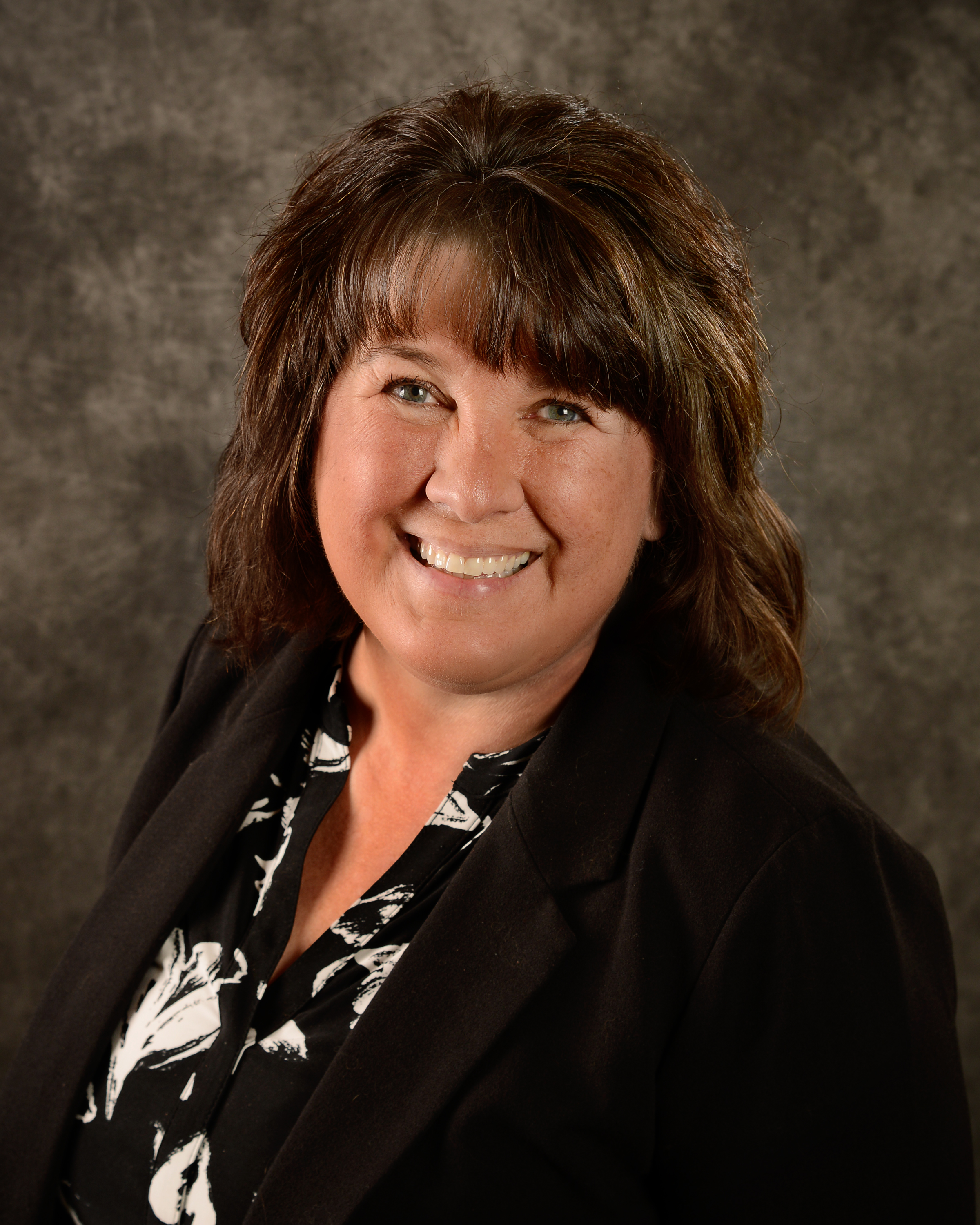 Photo of Mari Schupp, mid-length brown hair, and smiling