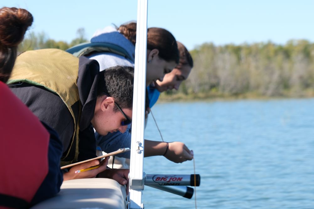 Students testing water on a boat