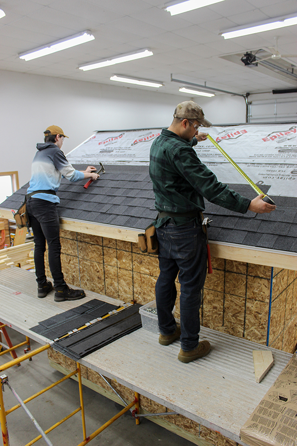 Construction Technology students working on the roof of a shed