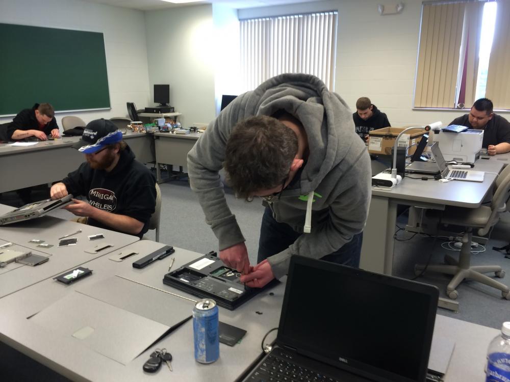 A picture of students working in a computer hardware class.
